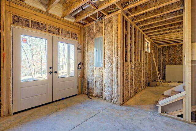 miscellaneous room with concrete floors and gas water heater