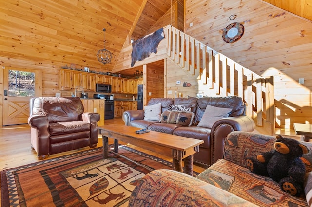 living room featuring wooden walls, light wood-type flooring, and high vaulted ceiling