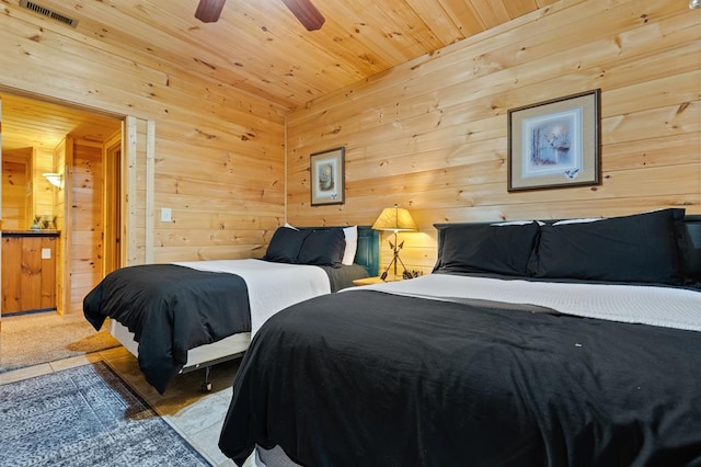 bedroom with wood ceiling, wood walls, and visible vents