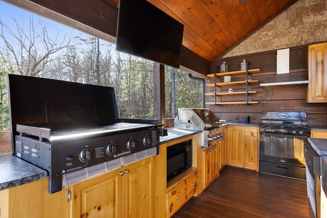 kitchen with wood ceiling, vaulted ceiling, wall chimney range hood, black appliances, and dark wood finished floors