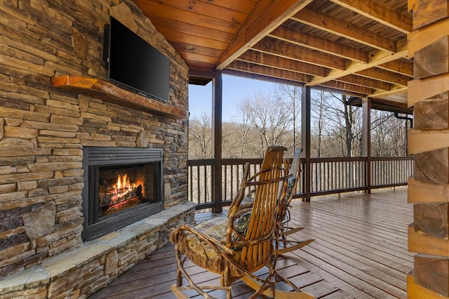 deck featuring an outdoor stone fireplace