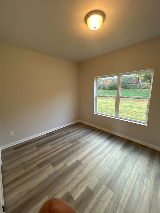 unfurnished room with hardwood / wood-style flooring