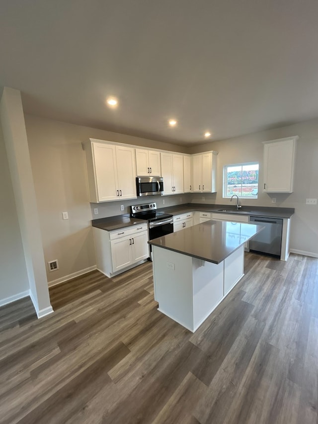 kitchen with a center island, white cabinets, and appliances with stainless steel finishes