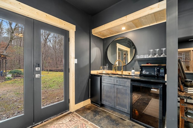 bar with sink, french doors, and beverage cooler