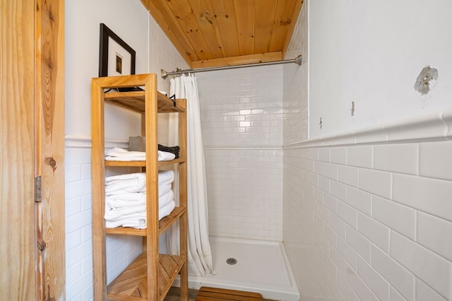 bathroom with wood ceiling, tile walls, and a shower with shower curtain