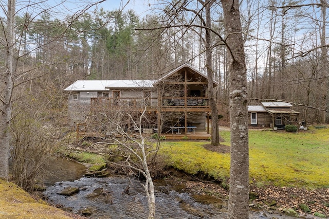 rear view of property featuring a yard