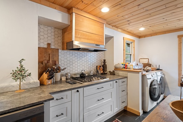 kitchen with stainless steel gas stovetop, white cabinetry, ventilation hood, backsplash, and independent washer and dryer