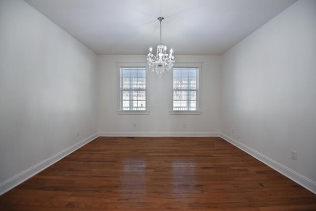 living room with a chandelier and dark hardwood / wood-style floors