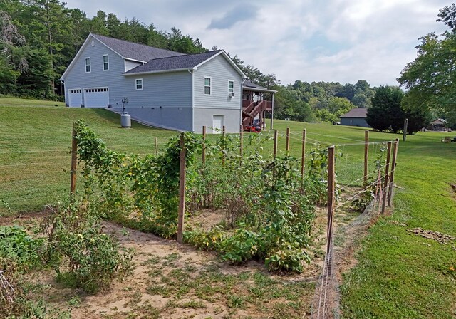 view of property exterior with a porch, a yard, and a garage