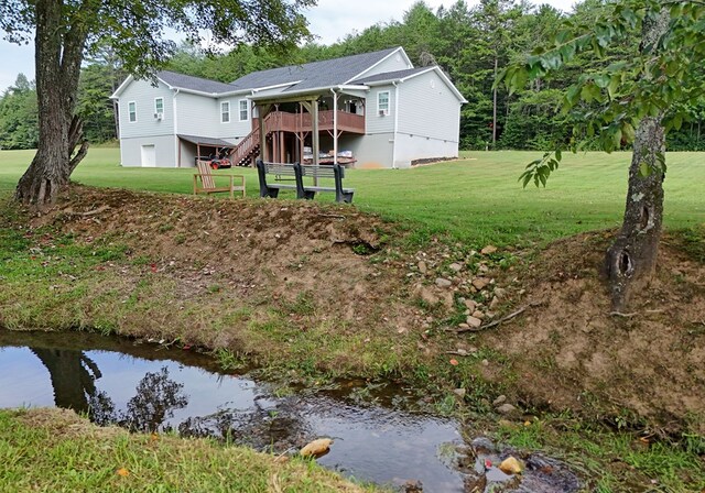 back of property featuring a lawn, cooling unit, and a wooden deck