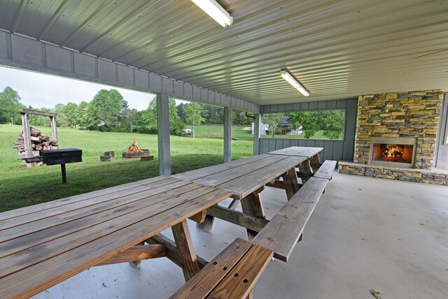 view of property's community featuring an outdoor fire pit and a yard