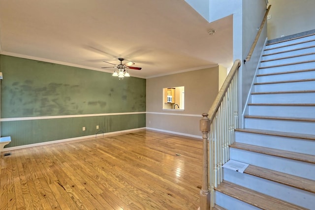 interior space with ceiling fan, crown molding, and hardwood / wood-style flooring