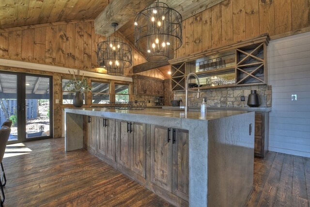kitchen with open shelves, beam ceiling, wood walls, french doors, and dark wood-style floors