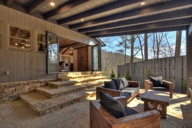 view of patio / terrace with an outdoor living space and fence