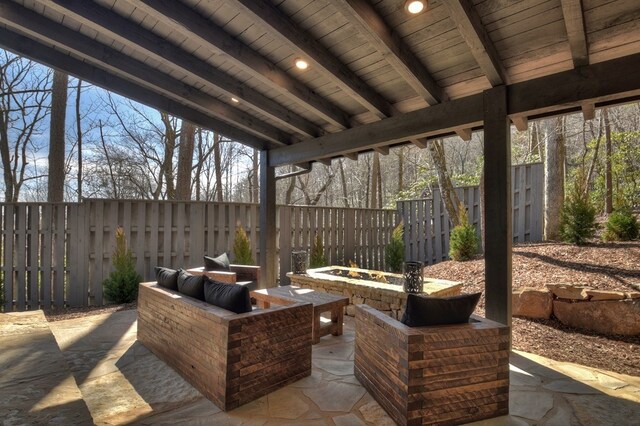view of patio with fence and an outdoor fire pit