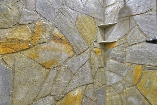interior details featuring tiled shower