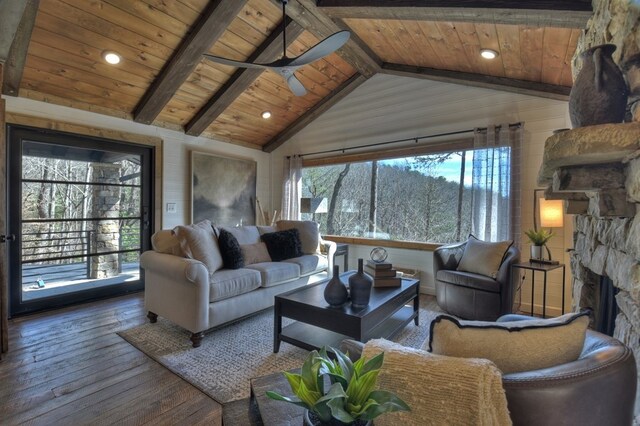 living area with a stone fireplace, wooden ceiling, vaulted ceiling with beams, and hardwood / wood-style floors