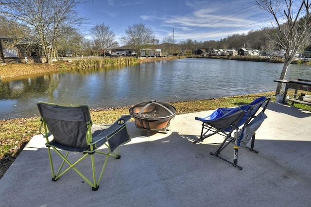 view of patio featuring a water view and a fire pit