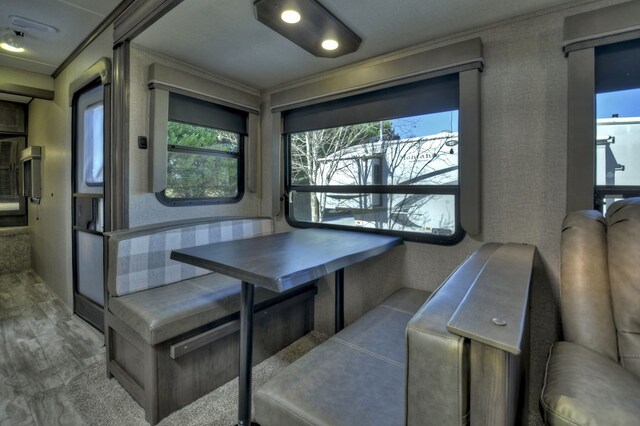 dining space with hardwood / wood-style floors and crown molding