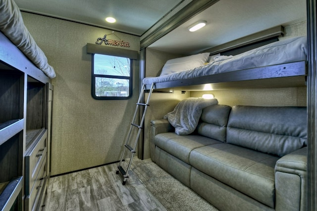 bedroom featuring a textured ceiling, light hardwood / wood-style flooring, and crown molding