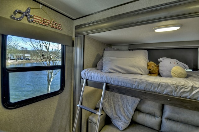 bedroom featuring a water view