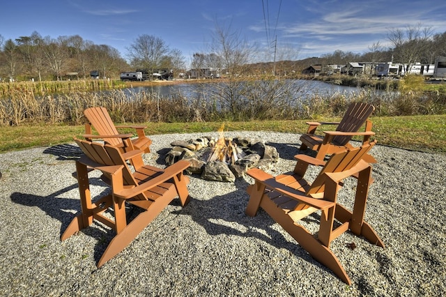 view of patio / terrace featuring a water view and a fire pit