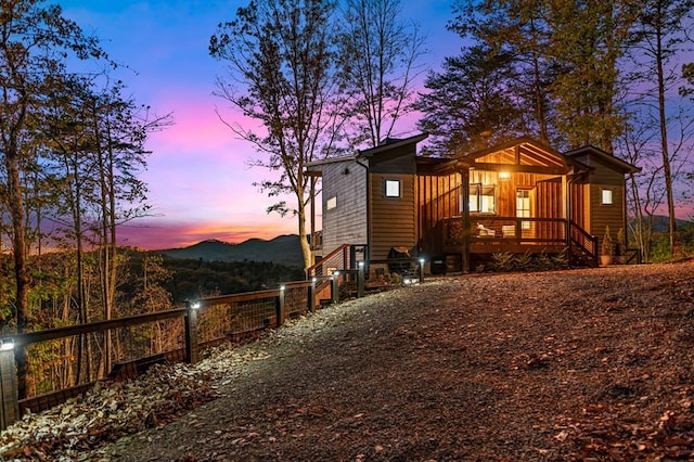 exterior space featuring board and batten siding and fence