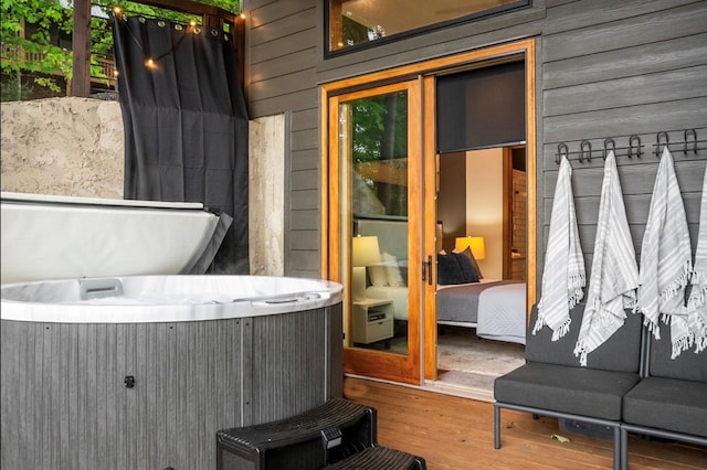 view of patio with a hot tub and a deck