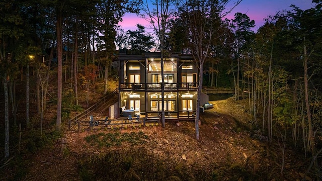 view of back of house at dusk