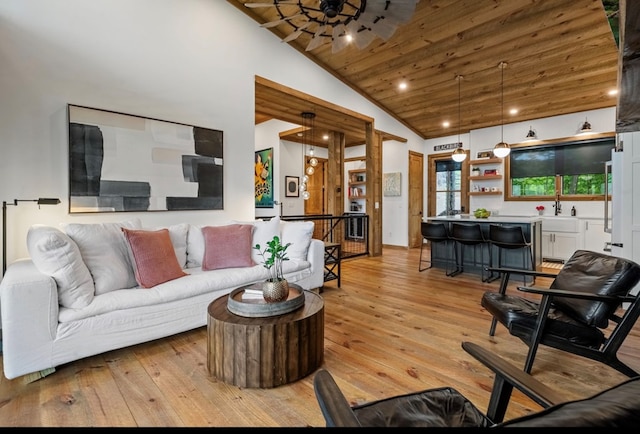 living area featuring high vaulted ceiling, wooden ceiling, light wood-style flooring, recessed lighting, and wet bar