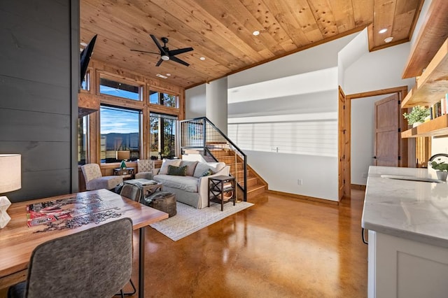 living area featuring recessed lighting, ceiling fan, wooden ceiling, concrete floors, and baseboards