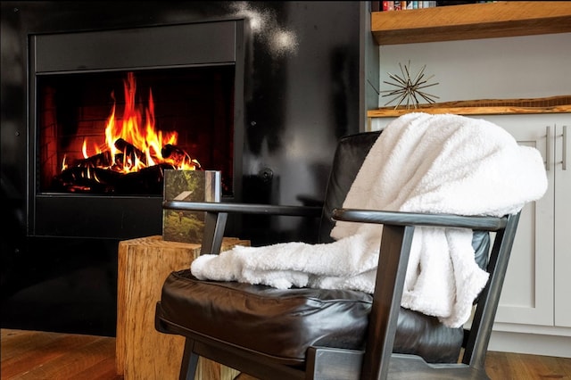 interior space featuring a lit fireplace and wood finished floors