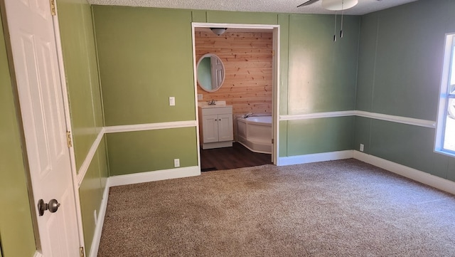 349 Kirby Ln, Murphy, NC 28906 - unfurnished bedroom with wooden walls, baseboards, dark carpet, and a textured ceiling
