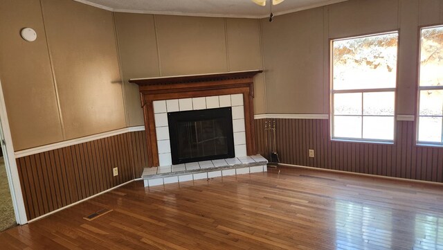 349 Kirby Ln, Murphy, NC 28906 - unfurnished living room with a decorative wall, wood-type flooring, visible vents, and a fireplace