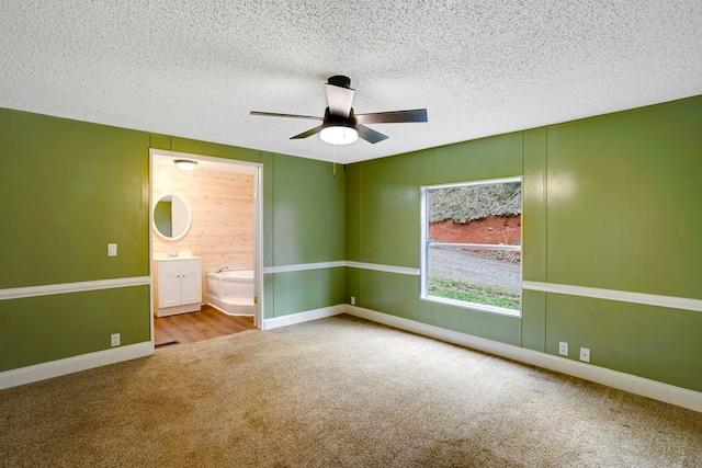 349 Kirby Ln, Murphy, NC 28906 - unfurnished bedroom featuring a textured ceiling, ensuite bathroom, a sink, and carpet floors