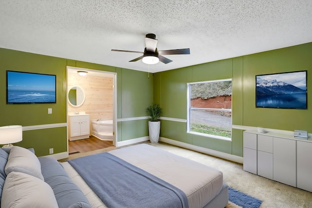 349 Kirby Ln, Murphy, NC 28906 - bedroom with baseboards, ensuite bathroom, a textured ceiling, ceiling fan, and a sink