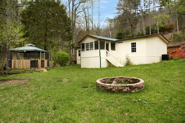 349 Kirby Ln, Murphy, NC 28906 - back of house featuring an outdoor fire pit, central AC, a gazebo, and a lawn