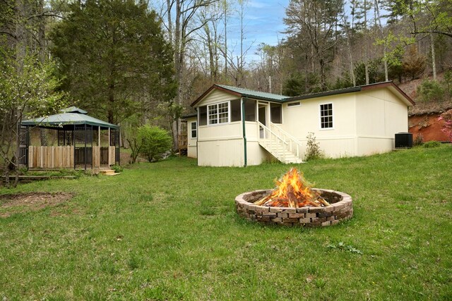 349 Kirby Ln, Murphy, NC 28906 - back of property with a gazebo, central air condition unit, a yard, and a fire pit