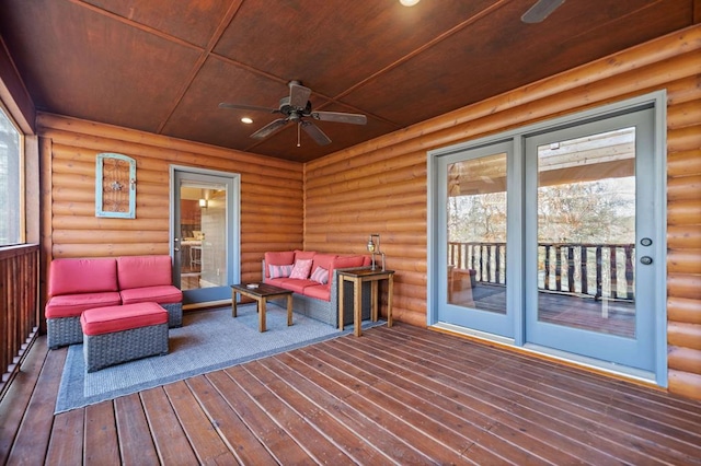 wooden terrace featuring ceiling fan and an outdoor living space