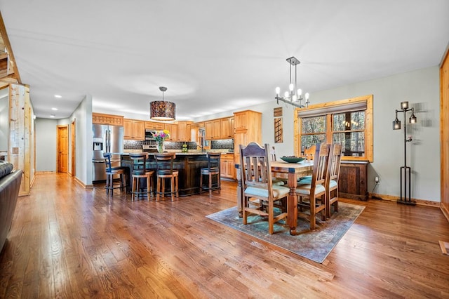 dining space with a chandelier and hardwood / wood-style floors