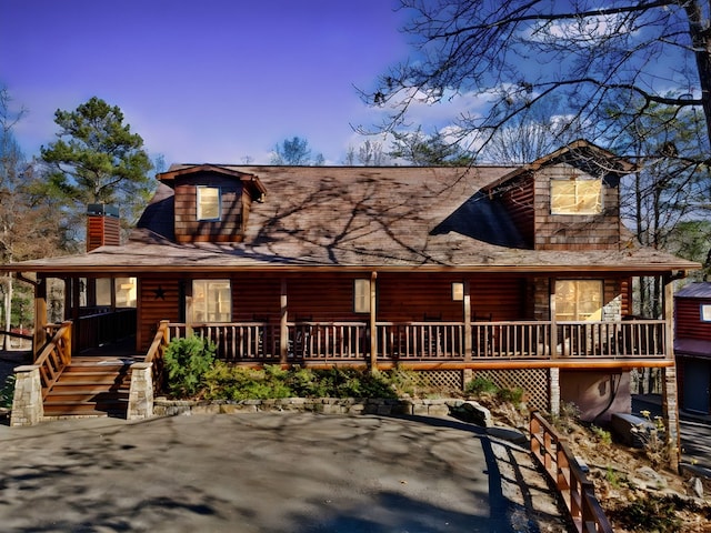 cabin featuring a porch