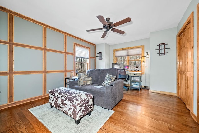 living room featuring ceiling fan and wood-type flooring