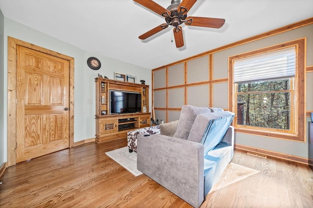 living room with hardwood / wood-style flooring and ceiling fan