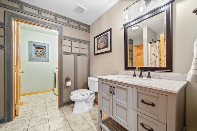 bathroom featuring toilet, a shower with curtain, tile patterned floors, and vanity