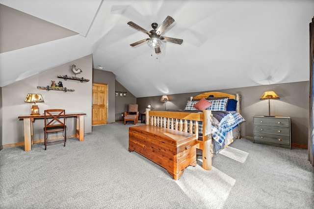 bedroom with ceiling fan, lofted ceiling, and carpet flooring