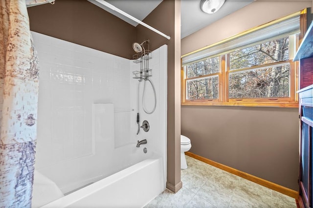 bathroom with toilet and washtub / shower combination