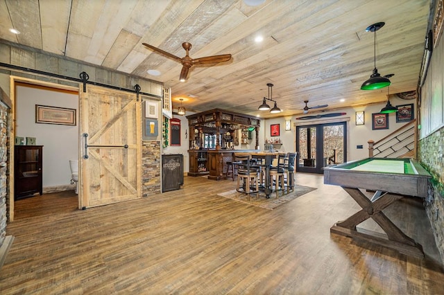 playroom with wooden ceiling, billiards, ceiling fan, wood-type flooring, and a barn door