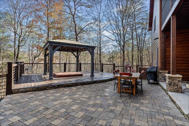 view of patio / terrace featuring a gazebo, grilling area, and a hot tub