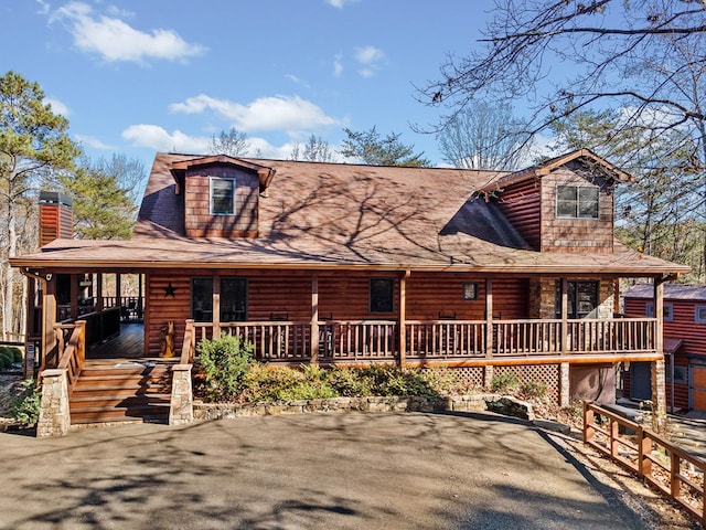 log home with covered porch