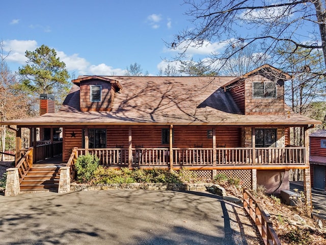 log-style house featuring a porch